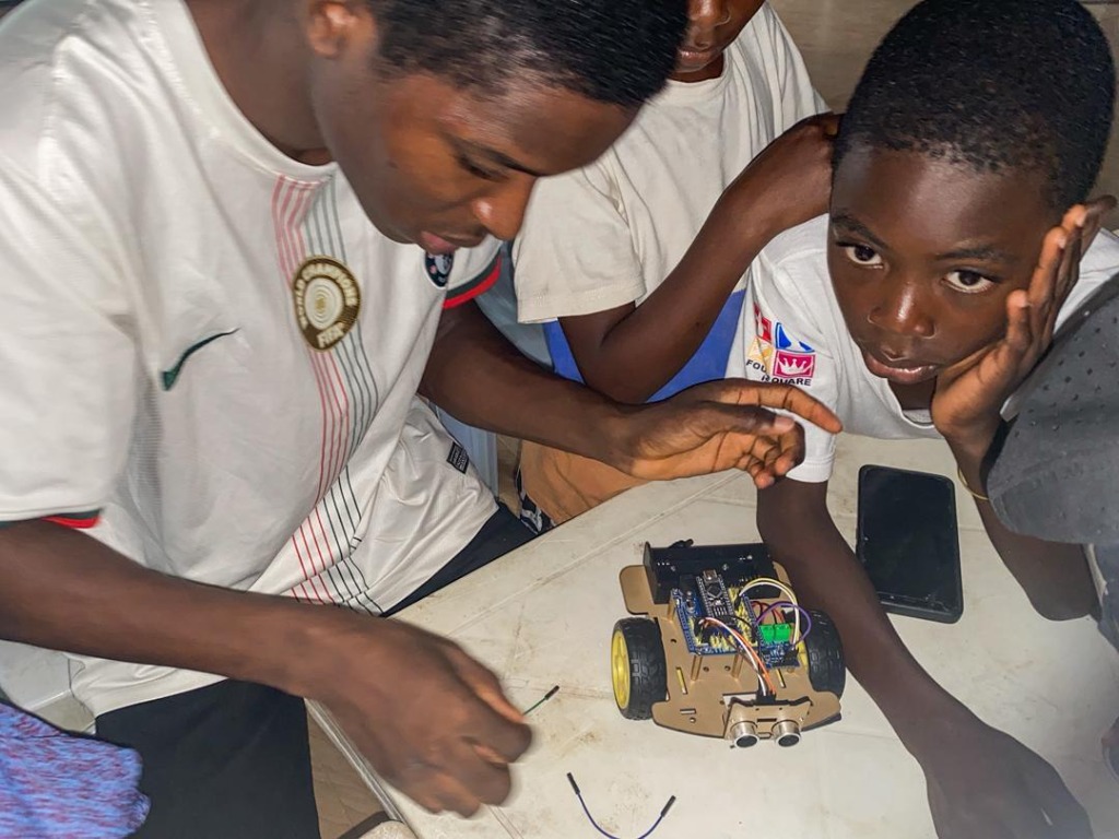 Instructors guiding students through wiring and programming